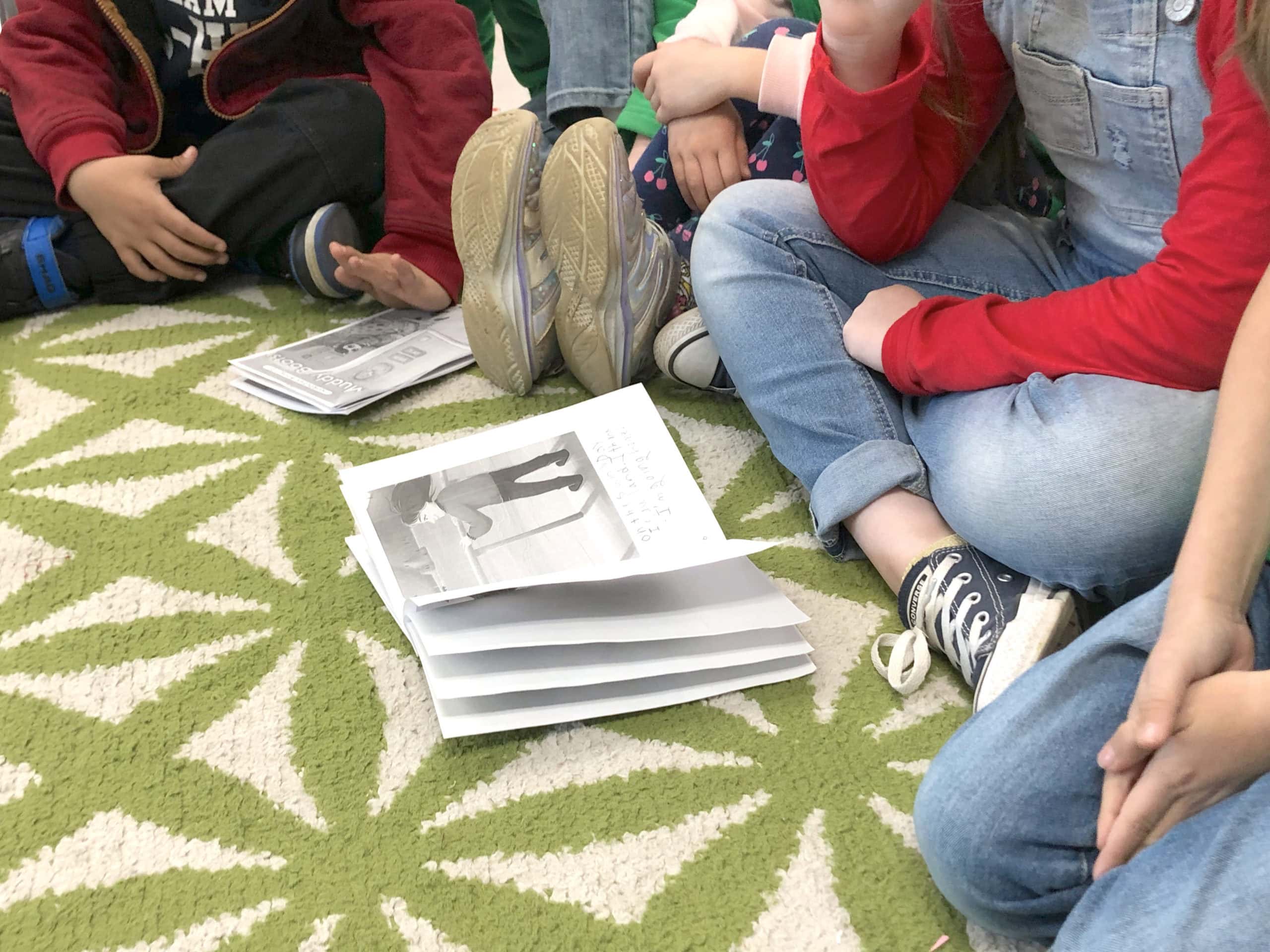 students looking at a wordless picture book