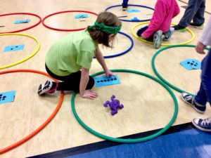 kids with hula hoops and numbers for math olympics