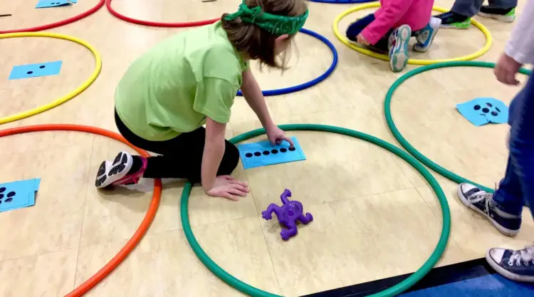 kids with hula hoops and numbers for math olympics